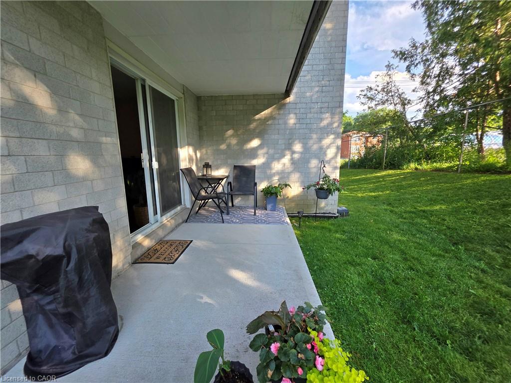 Covered patio featuring a concrete surface and light-toned brick exterior
