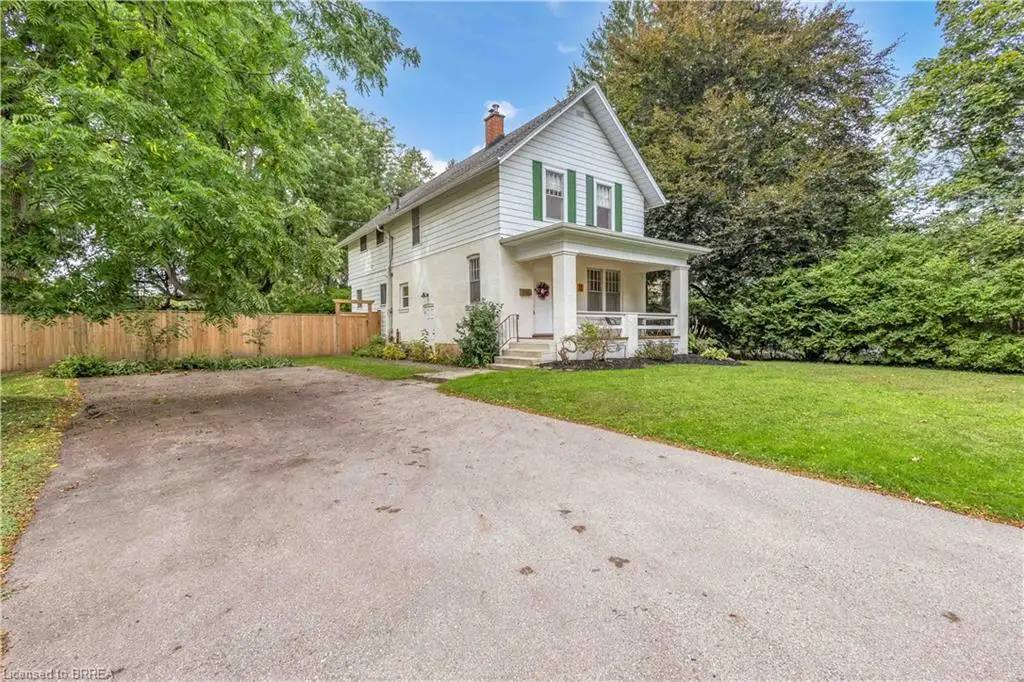 White siding exterior with green window shutters