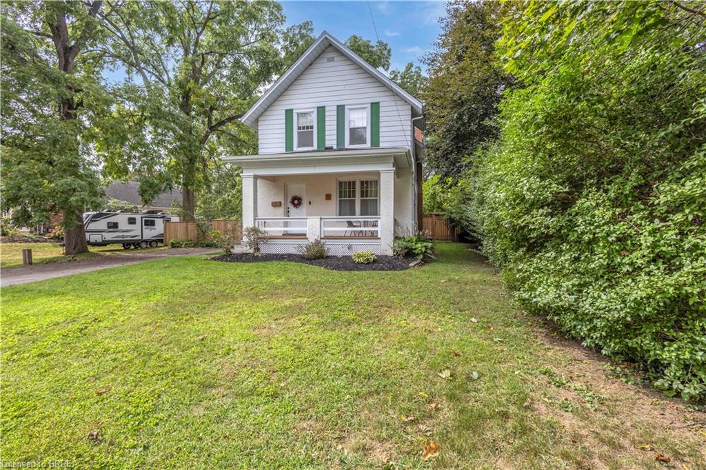White siding exterior with green window shutters