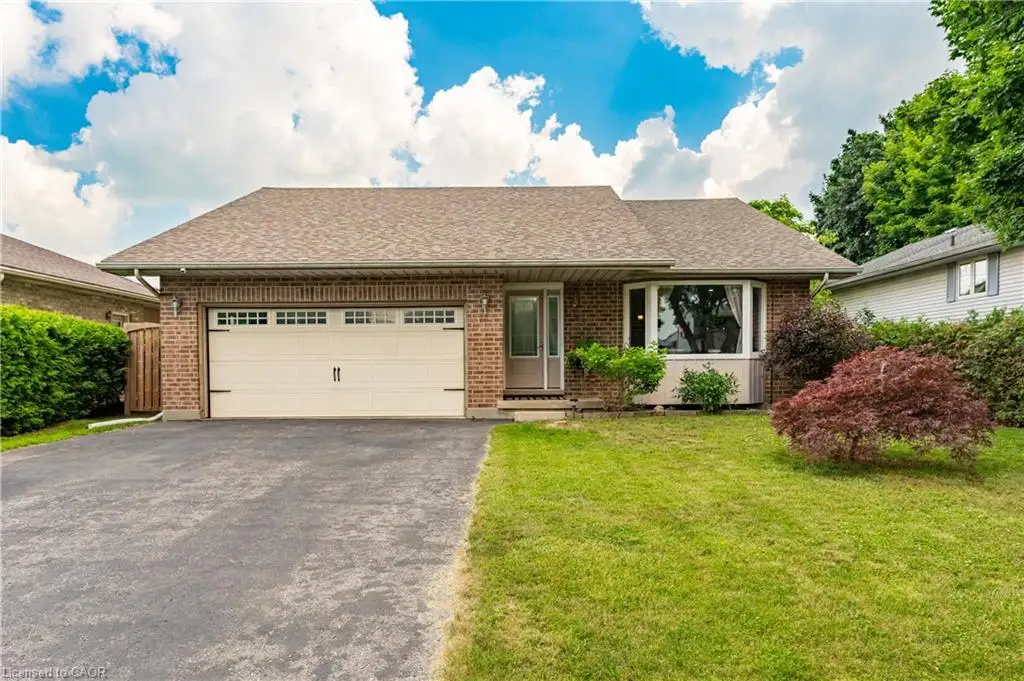 Brick facade residence with an attached garage and a paved driveway