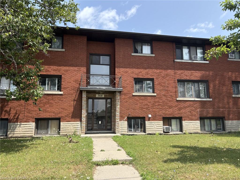 Brick facade structure featuring multiple windows
