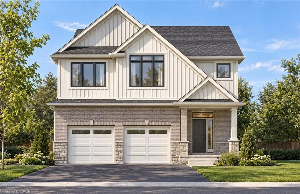 Two-story exterior featuring light brick masonry, vertical siding, an asphalt shingle roof, and an attached two-car garage