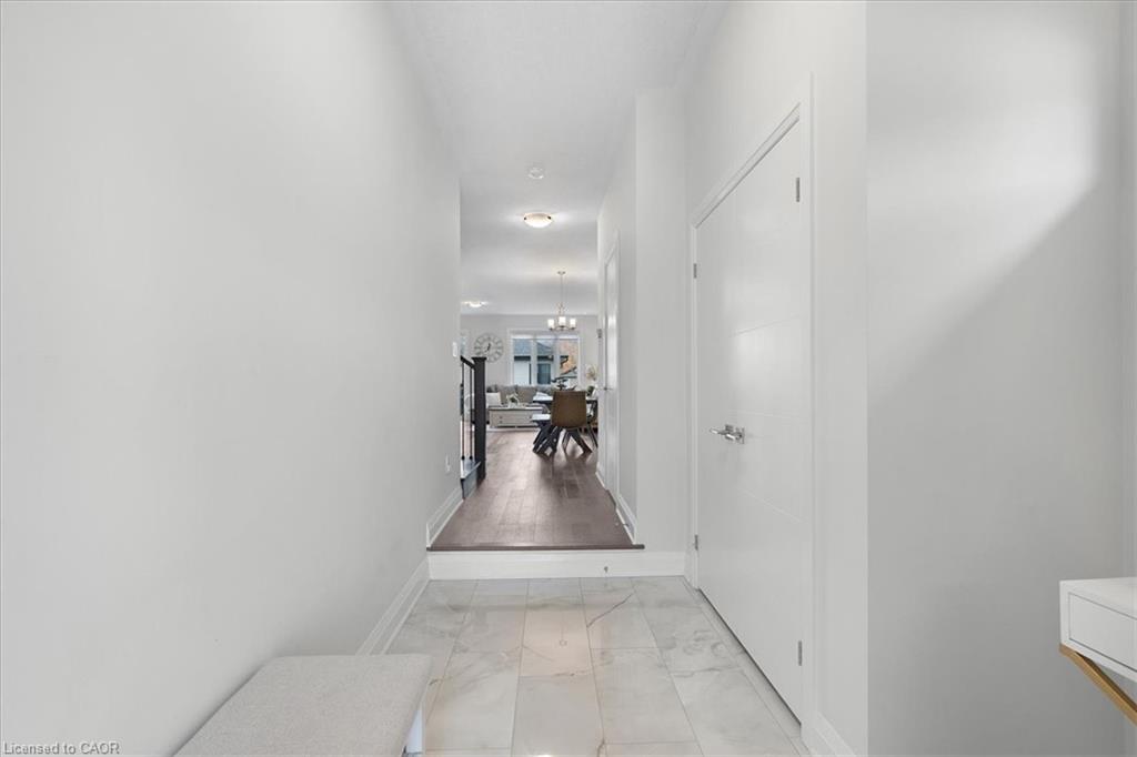 Entryway featuring large format tile flooring, a solid core door, and a clear sightline to the interior