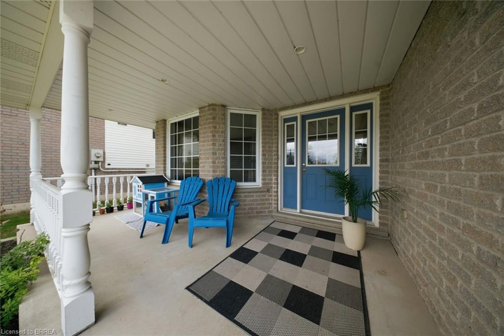 Covered front porch featuring brick exterior