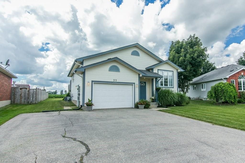 Contemporary home with light-colored siding, a dark blue entry door, and white trim accents