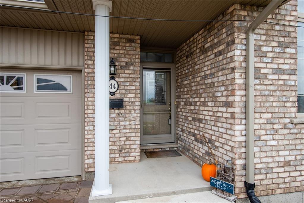 Brick facade with a single-car garage and a covered entrance