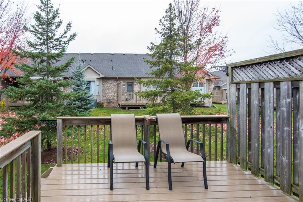 Wood-finish deck with a wood railing and lattice privacy screen