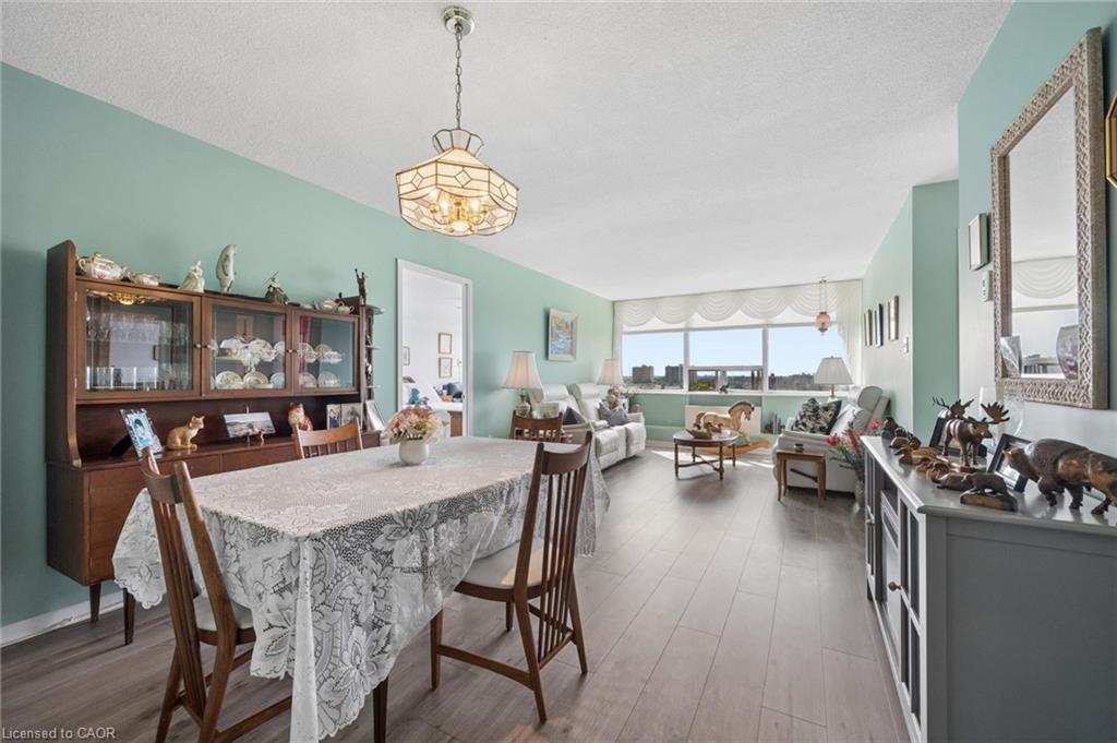 Spacious open-concept living area featuring wood-finish flooring and a panoramic window
