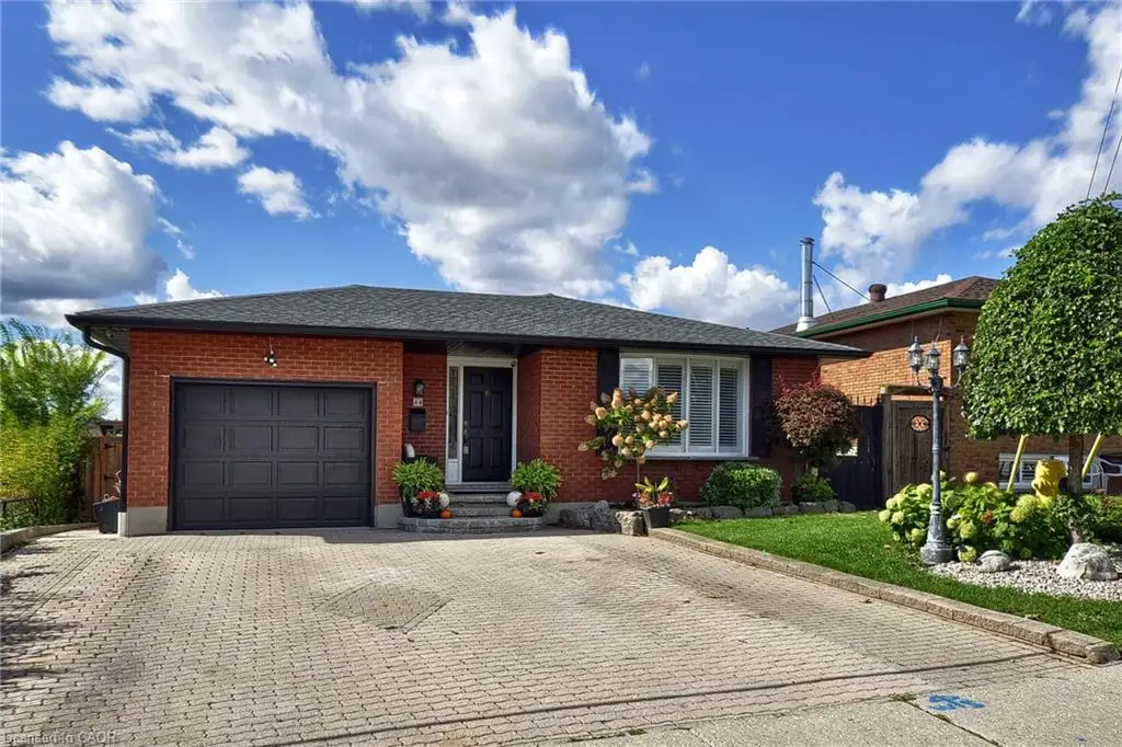 Brick exterior with a dark roof and a paved driveway