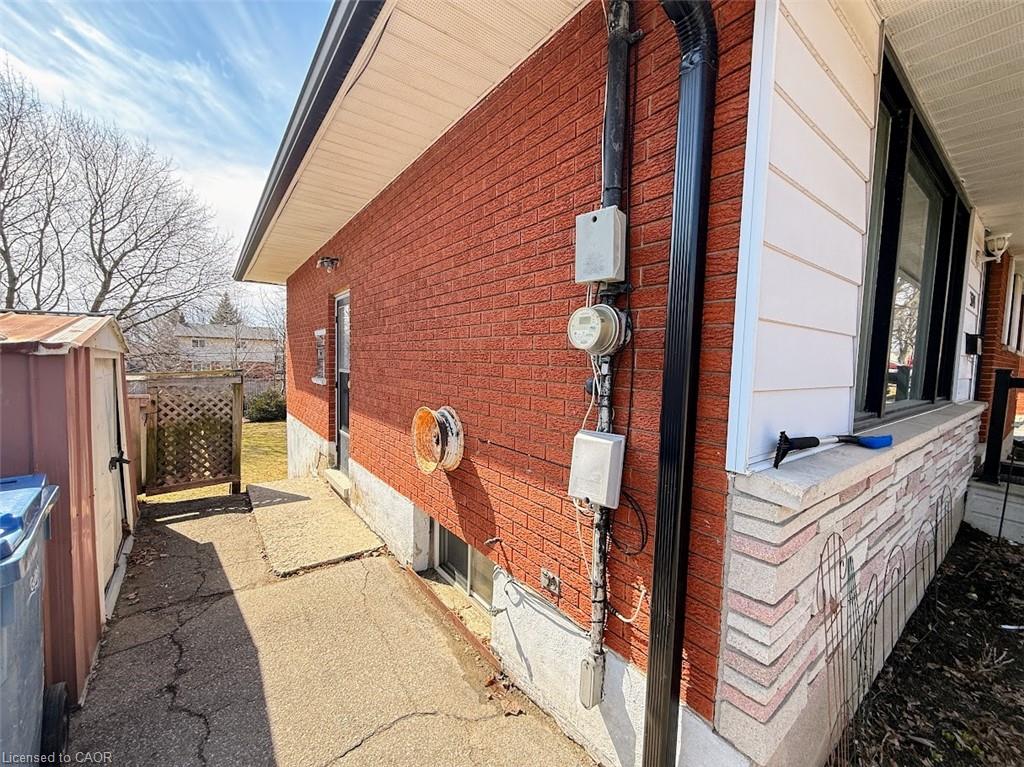 View of side of home featuring an outdoor structure
