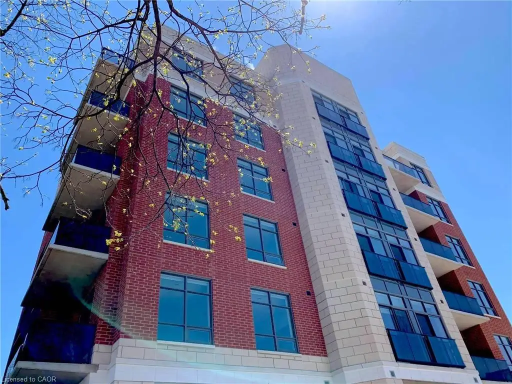 Brick and stone exterior with extensive window placements, glass panel balconies, and concrete balcony slabs