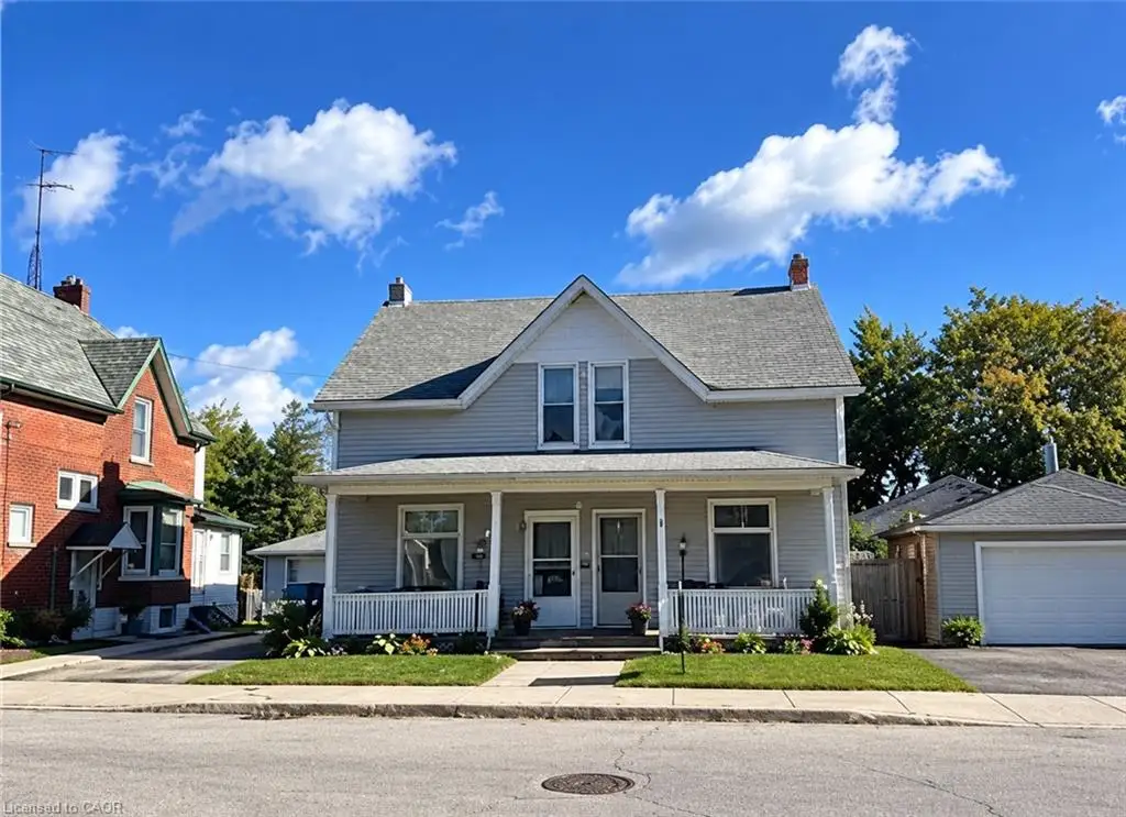 Two semis- two story residence with a covered front porch featuring white railings