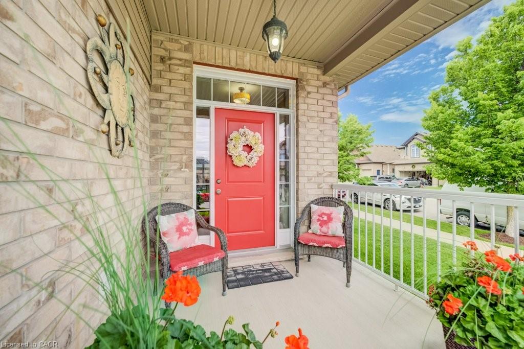 Inviting brick facade with a vibrant red entry door