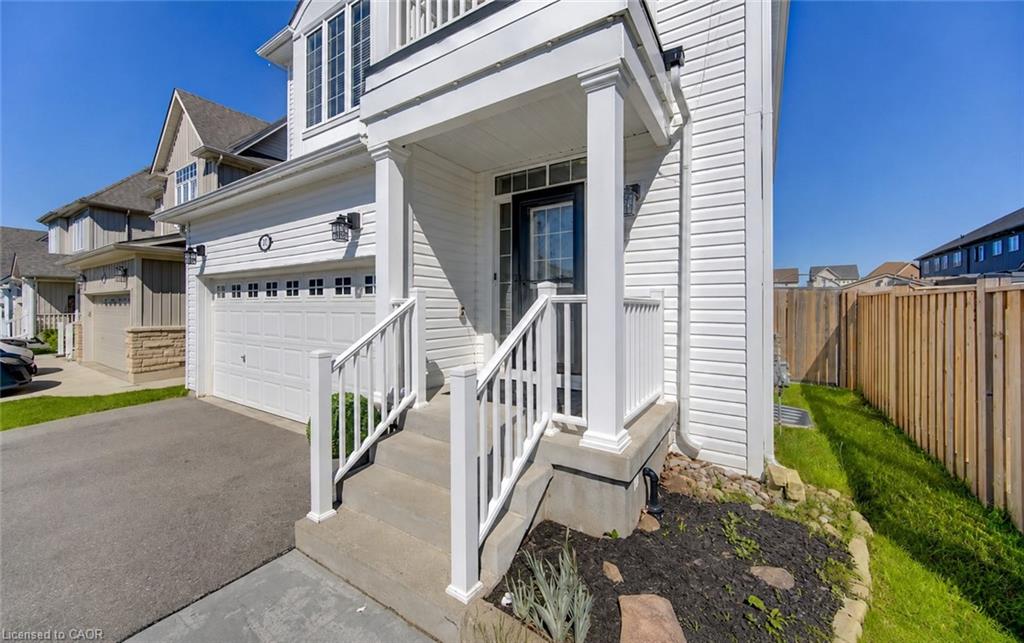 White siding exterior with a covered porch and concrete steps