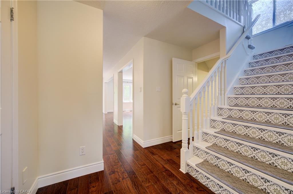 Grand staircase featuring patterned risers and white balusters