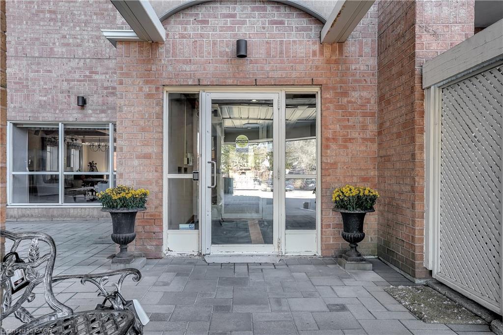 Brick exterior featuring a glass entry door with a sidelight, a transom, and an arched architectural element