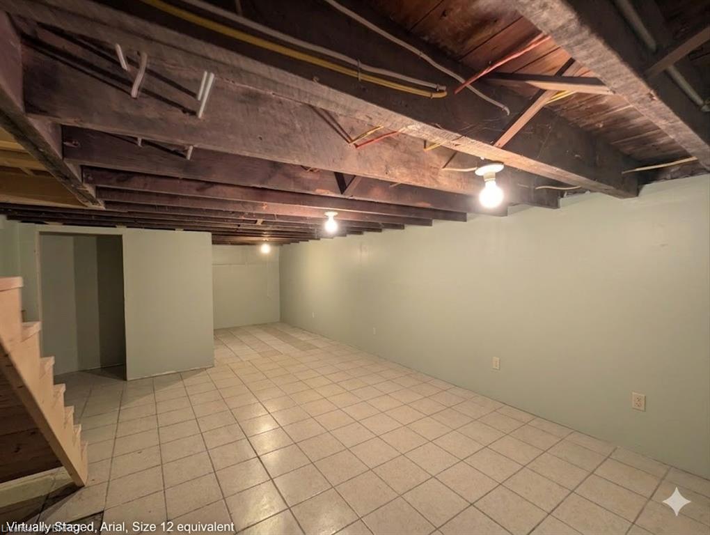Spacious lower level featuring tile flooring and painted walls