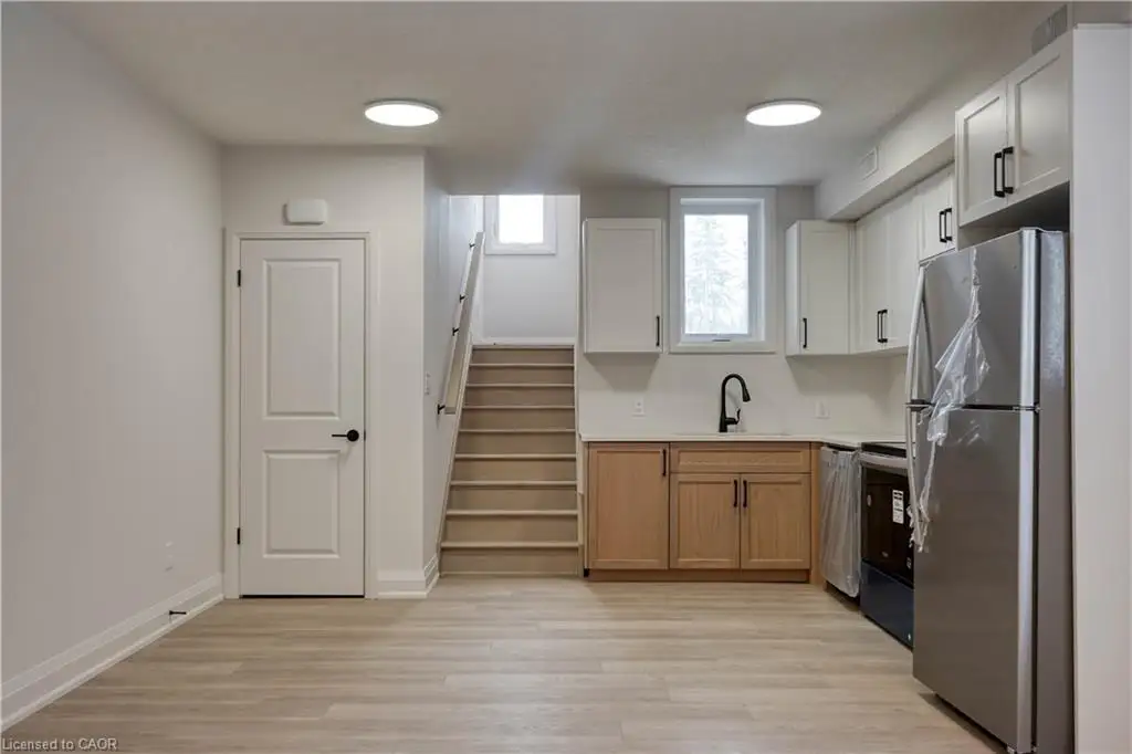 Kitchen featuring appliances with stainless steel finishes, light wood-type flooring, and light countertops