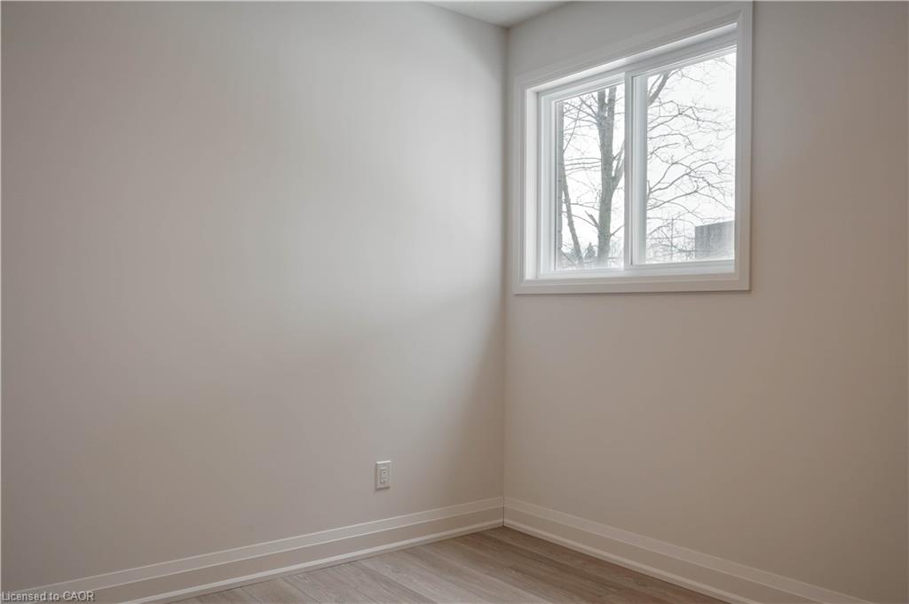 Unfurnished room featuring light wood-type flooring and baseboards