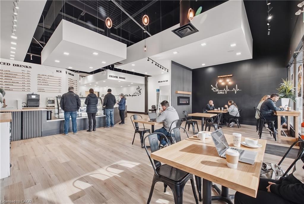 Light wood-finish flooring, recessed lighting, track lighting, and pendant lighting illuminate the space