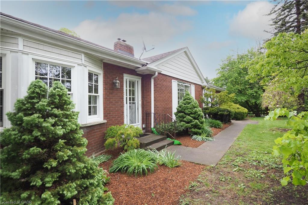Brick exterior with white siding accents and bay window