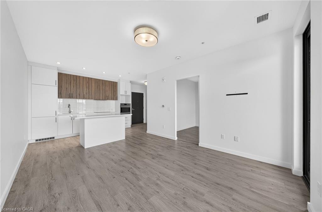 Open-concept living area featuring wood-finish flooring