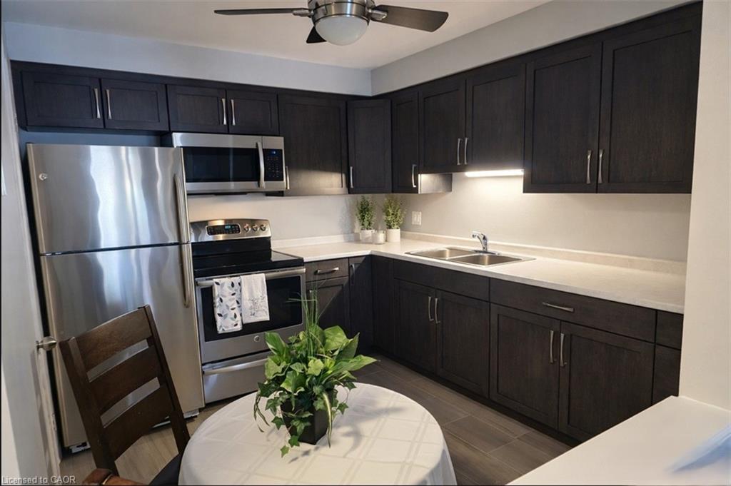 new kitchen with new counter tops, double sink, new lighting and floors