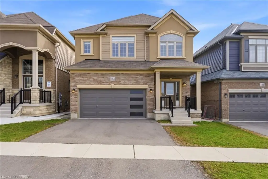 The property features a two-story design with a mix of brick and siding on the exterior