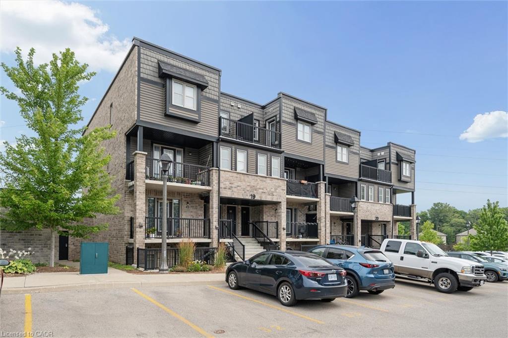 Modern multi-level building featuring a brick and siding exterior with individual balconies