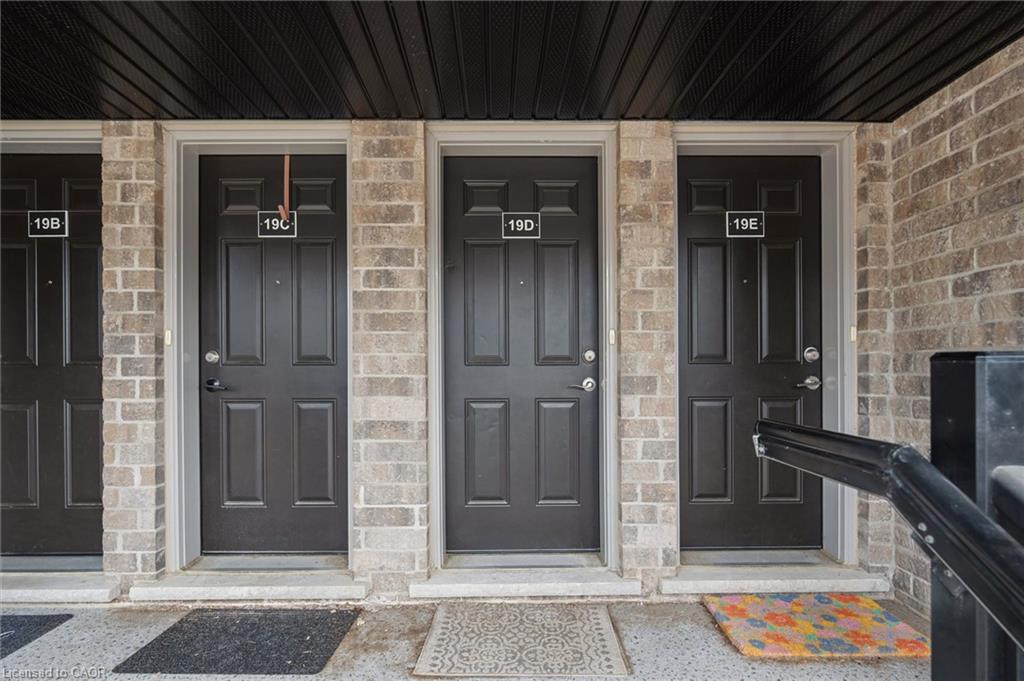 Exterior facade featuring multiple units with dark paneled entry doors
