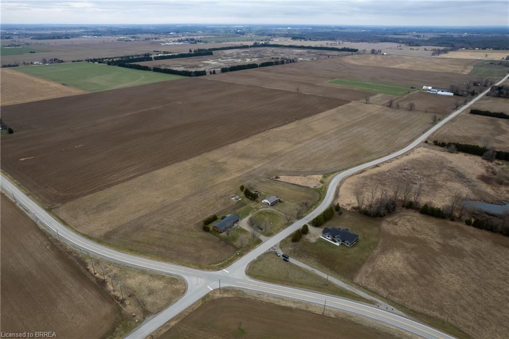 Aerial view of sparsely populated area with large plots for crops