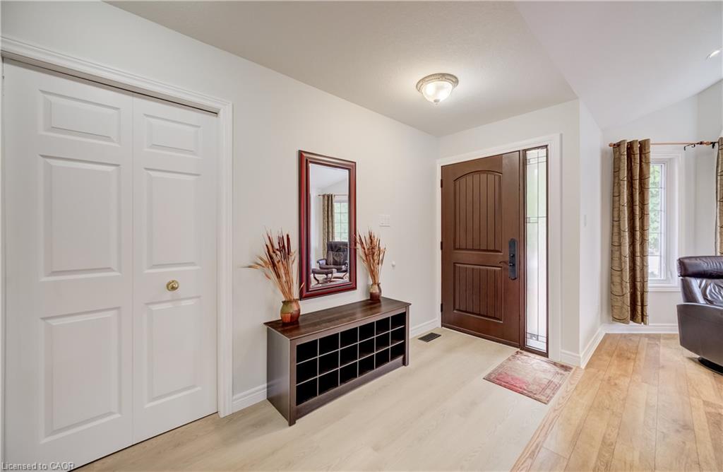 Light wood-finish flooring extending into the room