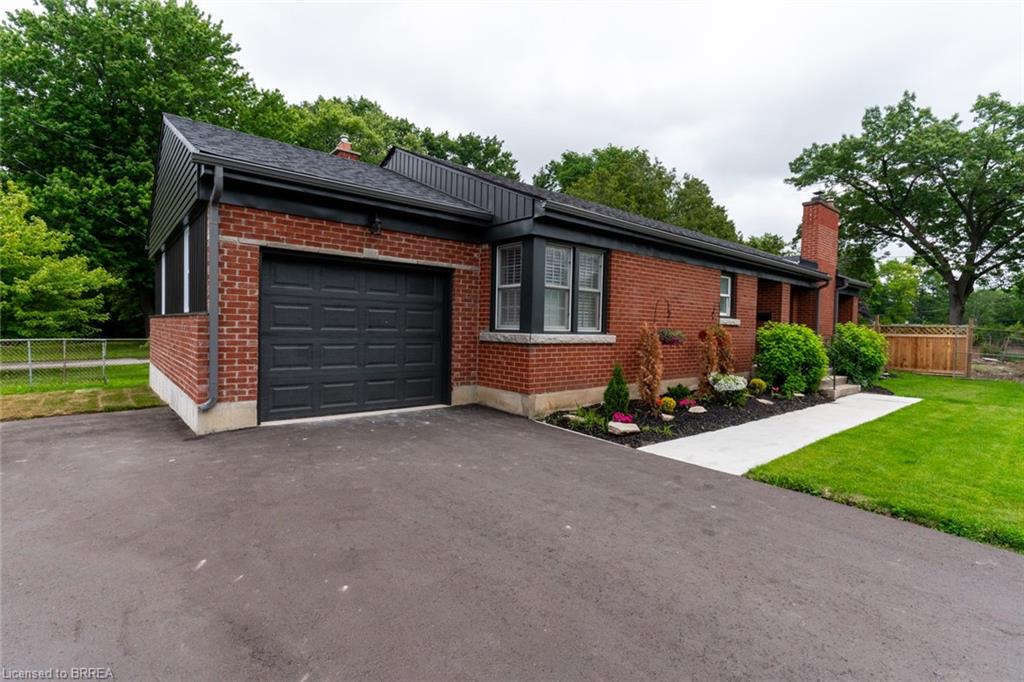 Brick exterior with a dark-paneled garage door