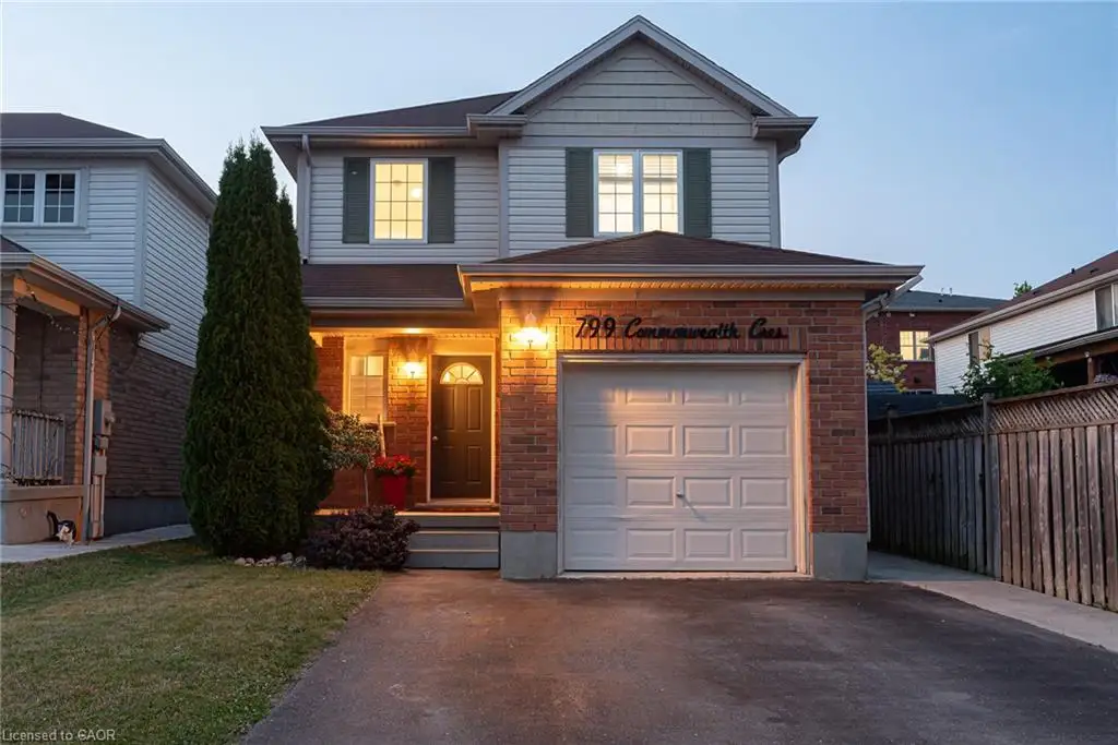 Two-story residence featuring a brick and siding exterior with a single-car garage