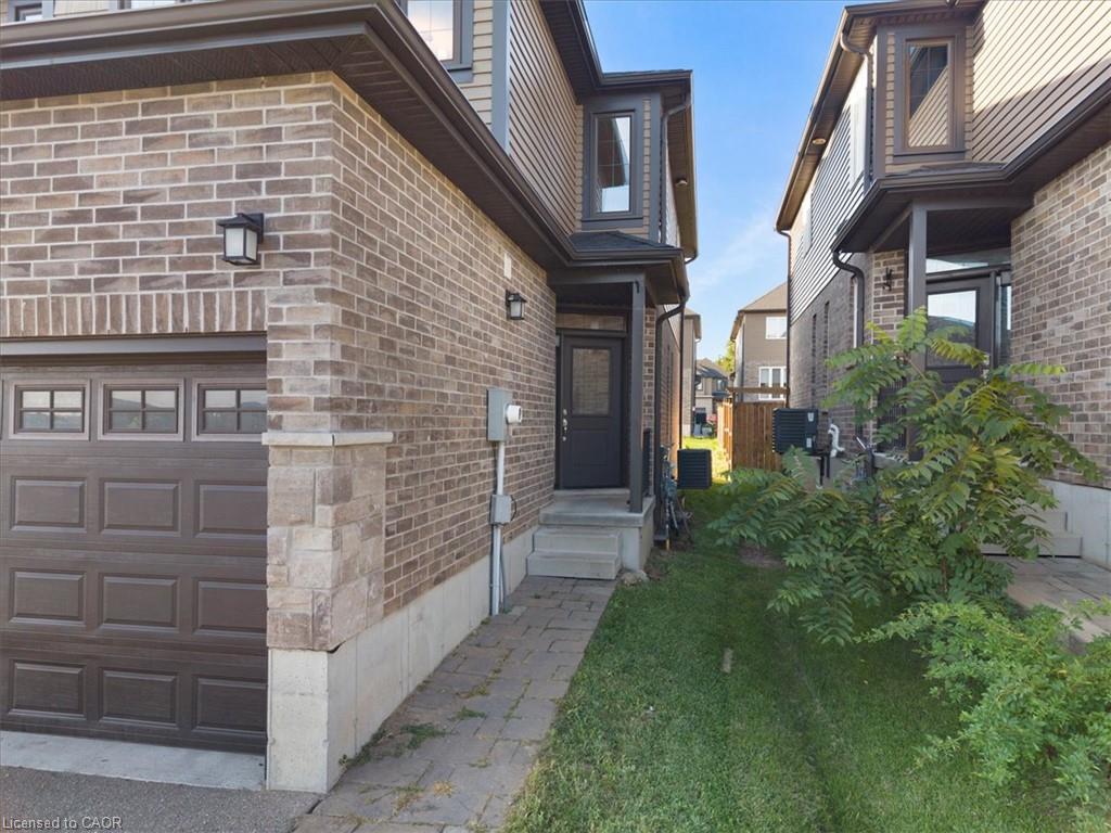 Brick and siding exterior with a paneled garage door