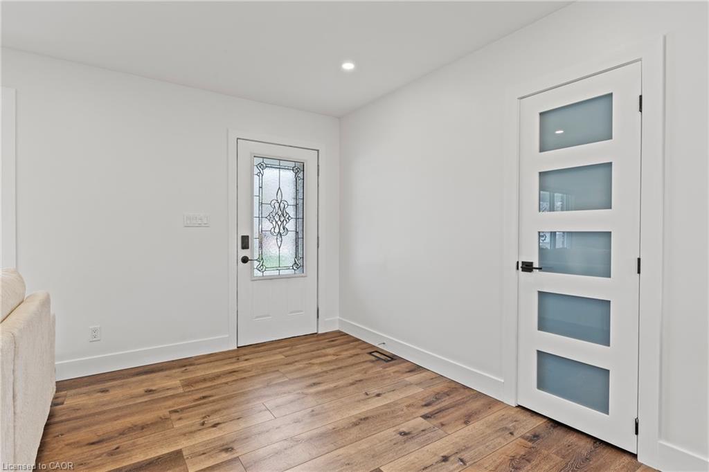 Entryway featuring wood-finish flooring, white walls, and a recessed ceiling light
