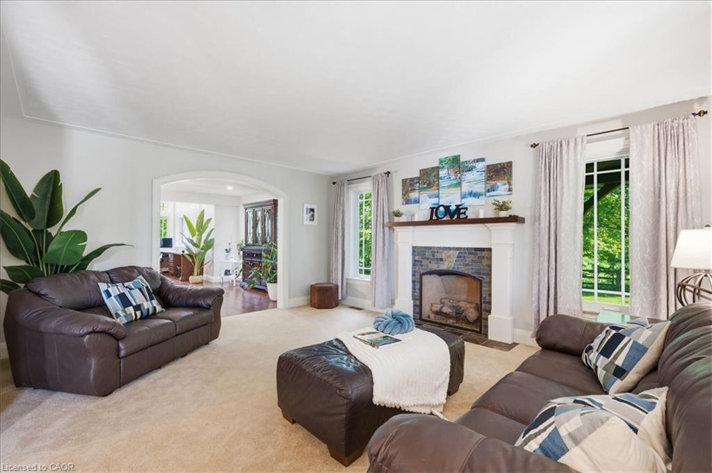 Living area featuring a natural gas fireplace with classic white mantel