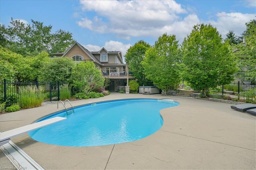 Outdoor saltwater swimming pool with a diving board and stamped concrete surround