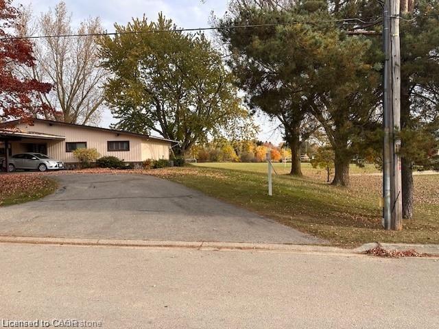 Single story home with driveway, a carport, and a front yard