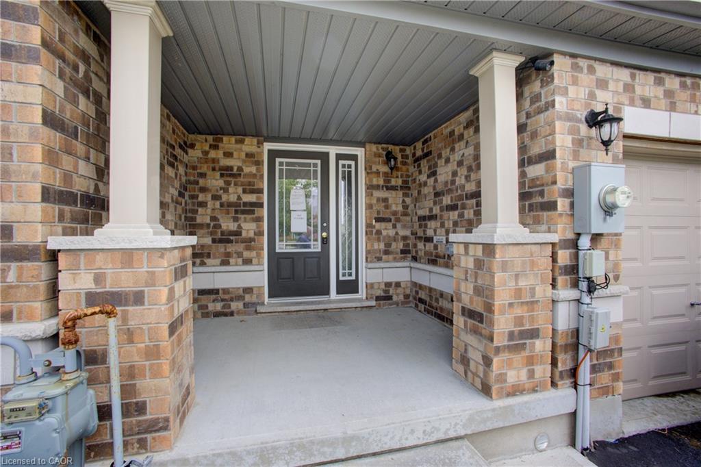 Brick facade with white columns and a covered concrete porch