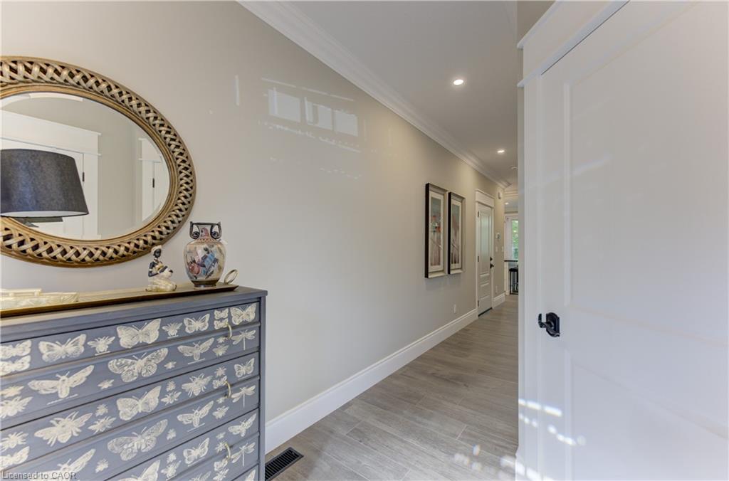 Recessed lighting, wood-finish flooring, and crown molding