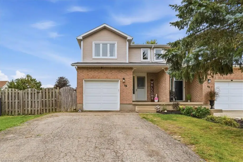 Brick and siding exterior with an attached garage, covered front entry, and a prominent front door