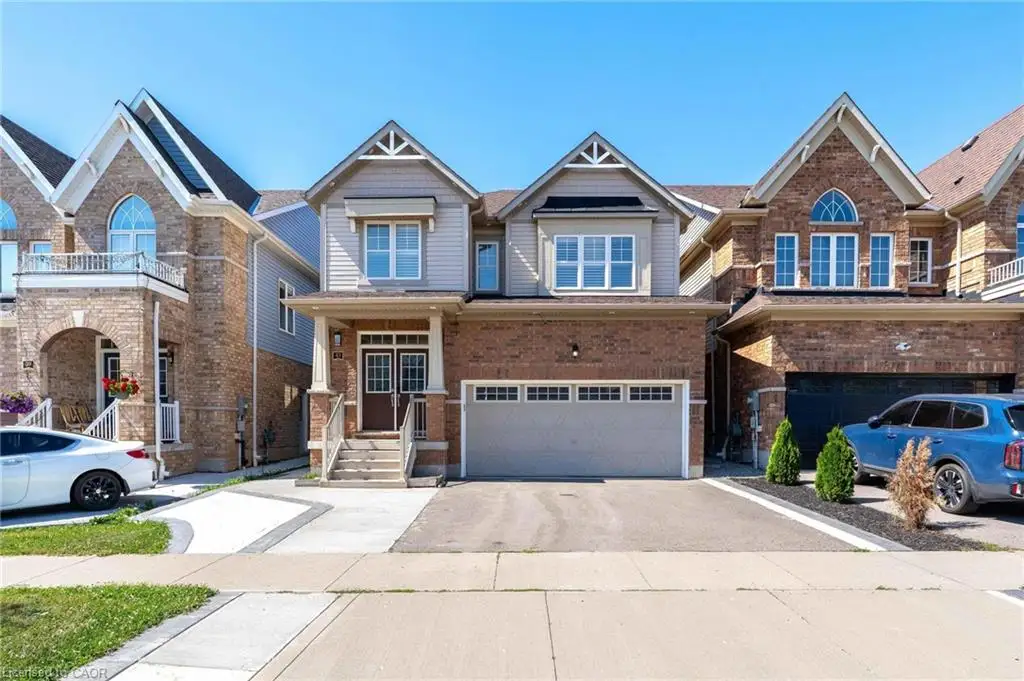 Brick and siding exterior featuring a covered front entry with double doors
