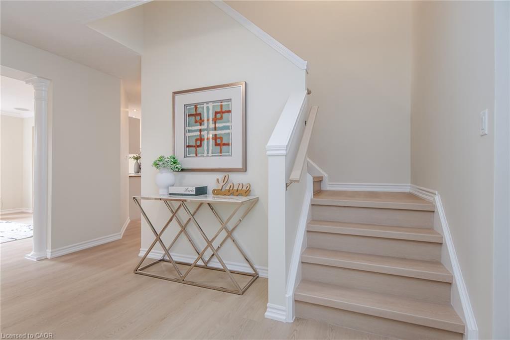 Light wood-finish flooring extending into an open entryway
