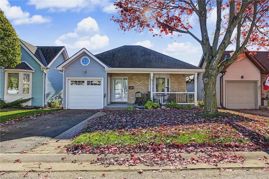 Single-story residence featuring a mixed-material exterior of horizontal siding and brick, an attached garage, a covered front porch, and a decorative octagonal window