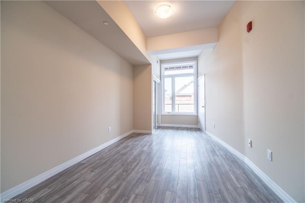 Empty room with dark wood-style floors and baseboards