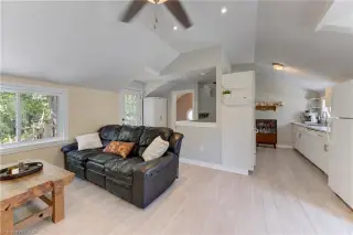 Open-concept living space featuring wood-finish flooring, recessed lighting, and a ceiling fan