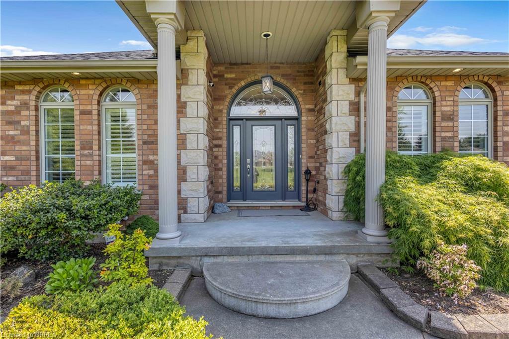 Brick facade with stone accents and a covered entryway