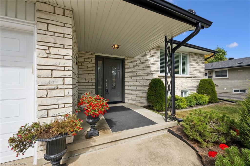 Stone veneer exterior with a covered entry, dark grey front door, and a single-car garage
