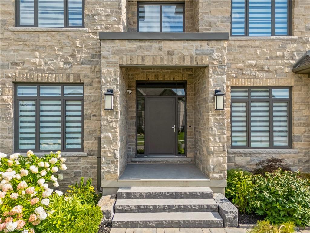 Stone veneer exterior with a covered entry